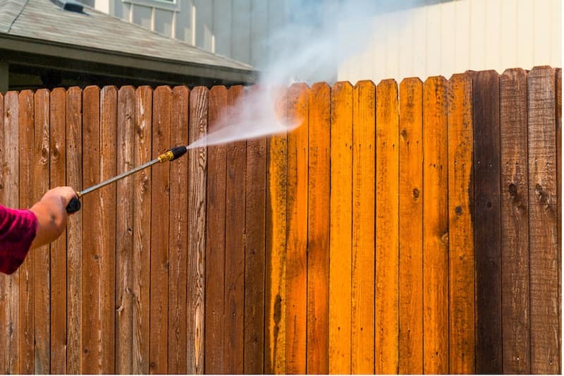 Pressure washing a wooden fence to prevent wood rot